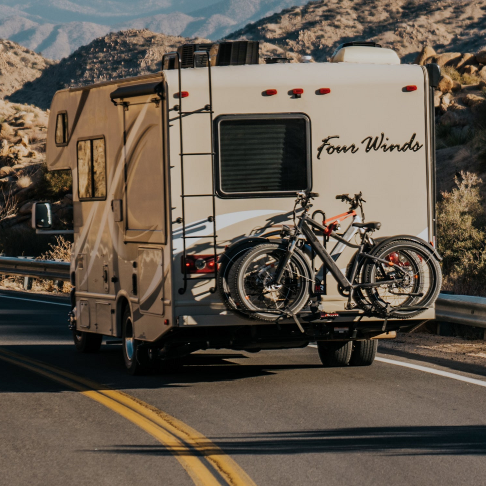 RV with bicycles on a scenic road