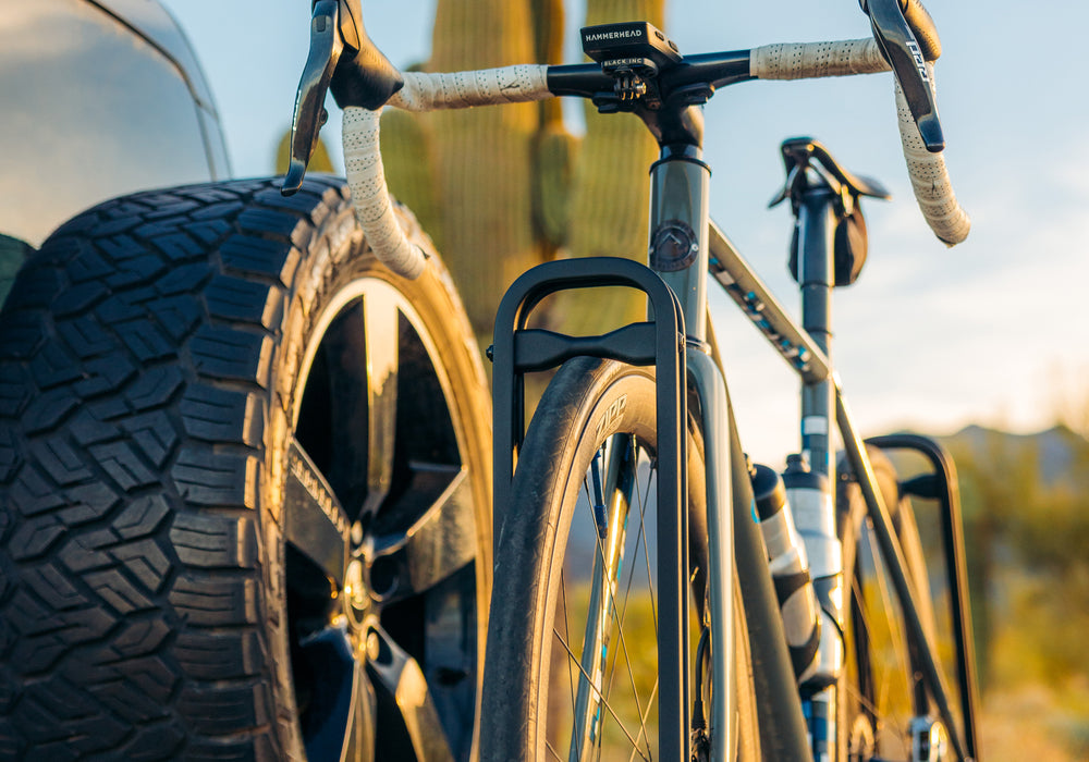 Close-up of a bike rack holding a bicycle with a blurred natural background